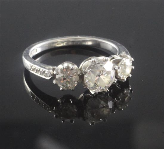 A platinum and three stone diamond ring, size N.